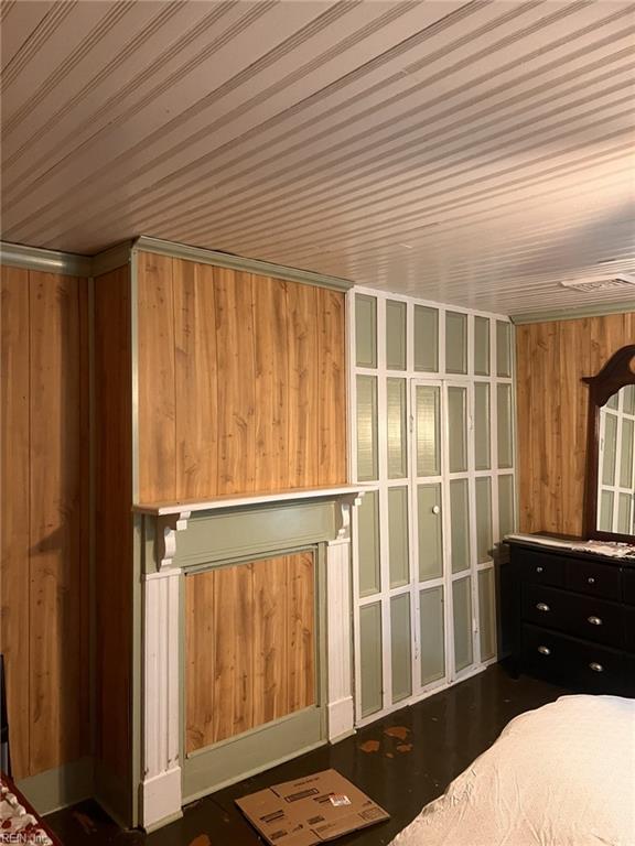 1717 Old Ferry Rd, Hudgins, VA 23076 - unfurnished bedroom with wood walls, wooden ceiling, and wood finished floors