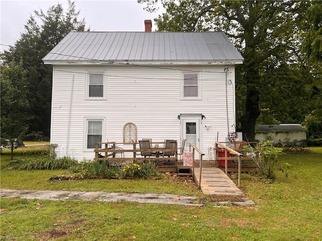 1717 Old Ferry Rd, Hudgins, VA 23076 - rear view of property with a deck, a yard, metal roof, a chimney, and a standing seam roof