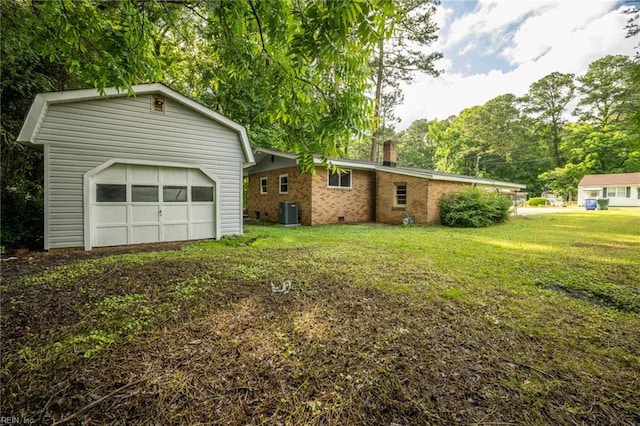 917 Garfield Ave, Suffolk, VA 23434 - view of front facade featuring a chimney, cooling unit, a front yard, an outbuilding, and brick siding