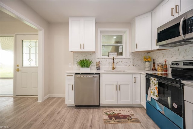 917 Garfield Ave, Suffolk, VA 23434 - kitchen featuring stainless steel appliances, a sink, tasteful backsplash, white cabinets, and light countertops