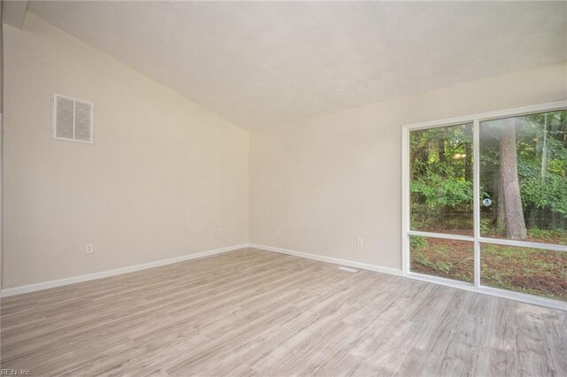917 Garfield Ave, Suffolk, VA 23434 - unfurnished room featuring light wood finished floors, vaulted ceiling, and baseboards