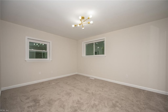 917 Garfield Ave, Suffolk, VA 23434 - carpeted empty room with a chandelier and baseboards