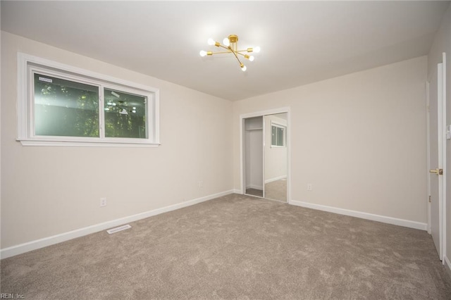 917 Garfield Ave, Suffolk, VA 23434 - unfurnished bedroom with a chandelier, carpet, a closet, and baseboards