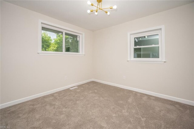 917 Garfield Ave, Suffolk, VA 23434 - unfurnished room with a chandelier, carpet floors, and baseboards