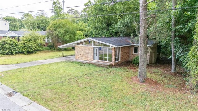 917 Garfield Ave, Suffolk, VA 23434 - view of grassy yard with driveway and a carport