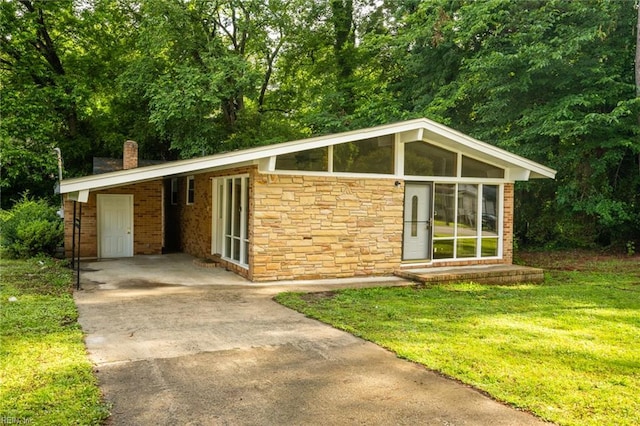 917 Garfield Ave, Suffolk, VA 23434 - mid-century modern home featuring stone siding, driveway, a chimney, a carport, and a front yard