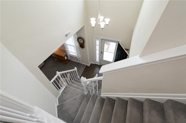 302 Peachwood Ct, Suffolk, VA 23434 - staircase with a high ceiling, a chandelier, and wood finished floors