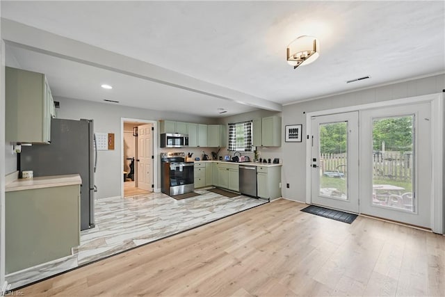 1840 Old Ridge Rd, Virginia Beach, VA 23464 - kitchen with green cabinetry, appliances with stainless steel finishes, light countertops, light wood-style flooring, and recessed lighting