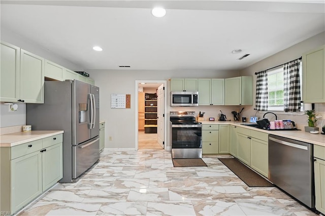 1840 Old Ridge Rd, Virginia Beach, VA 23464 - kitchen with stainless steel appliances, green cabinets, recessed lighting, a sink, and light countertops