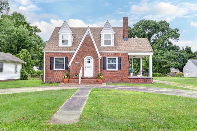 319 Greenbriar Ave, Hampton, VA 23661 - tudor-style house featuring brick siding, a front lawn, a chimney, and crawl space