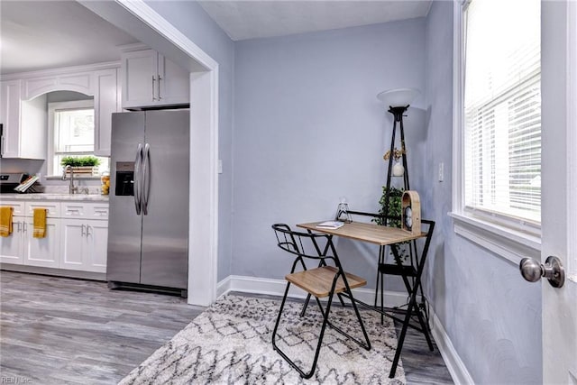 319 Greenbriar Ave, Hampton, VA 23661 - kitchen with stainless steel fridge with ice dispenser, white cabinetry, light wood-style flooring, baseboards, and light countertops