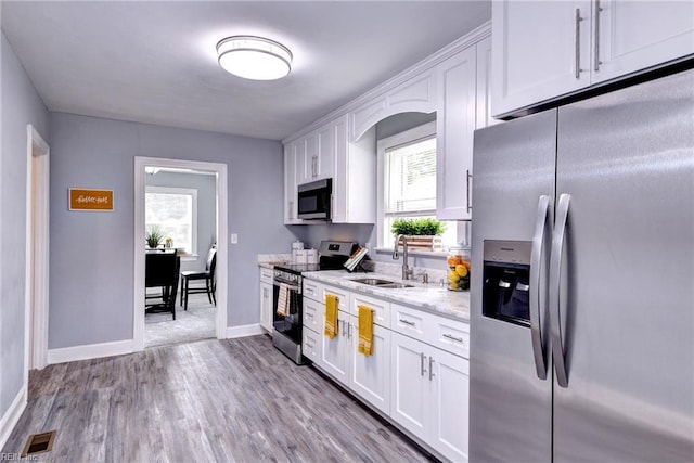 319 Greenbriar Ave, Hampton, VA 23661 - kitchen featuring stainless steel appliances, a sink, white cabinetry, and baseboards