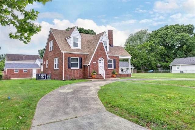 319 Greenbriar Ave, Hampton, VA 23661 - tudor-style house with brick siding, a chimney, curved driveway, and roof with shingles