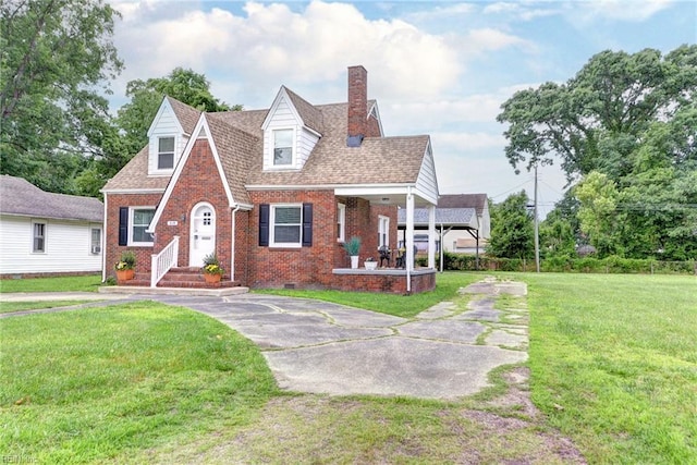 319 Greenbriar Ave, Hampton, VA 23661 - tudor house with brick siding, a chimney, a front lawn, and crawl space