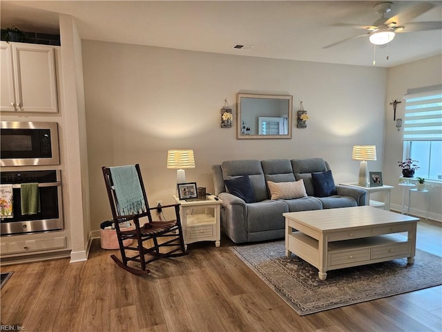23082 Retreat Ln, Carrollton, VA 23314 - living room with wood finished floors, a ceiling fan, and baseboards