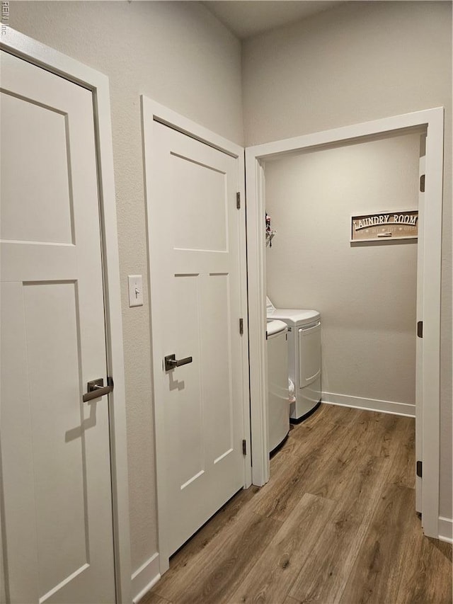 23082 Retreat Ln, Carrollton, VA 23314 - hallway featuring washer and clothes dryer, wood finished floors, and baseboards