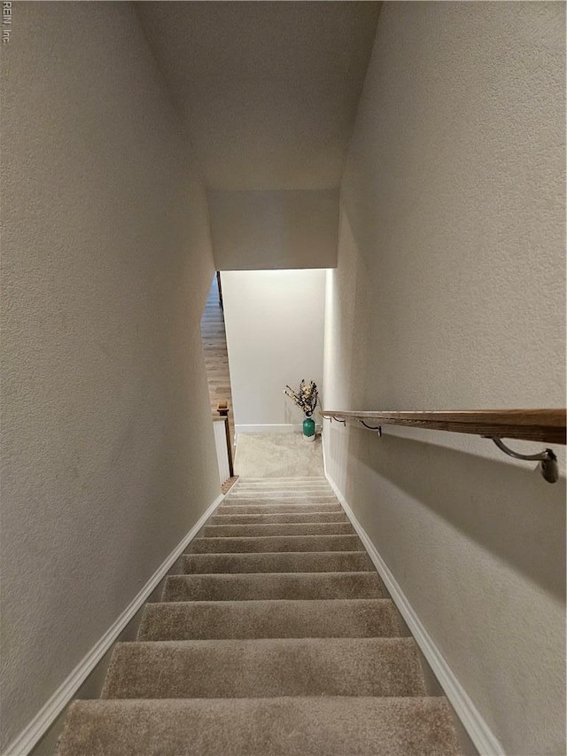 23082 Retreat Ln, Carrollton, VA 23314 - staircase featuring a textured wall, carpet flooring, and baseboards