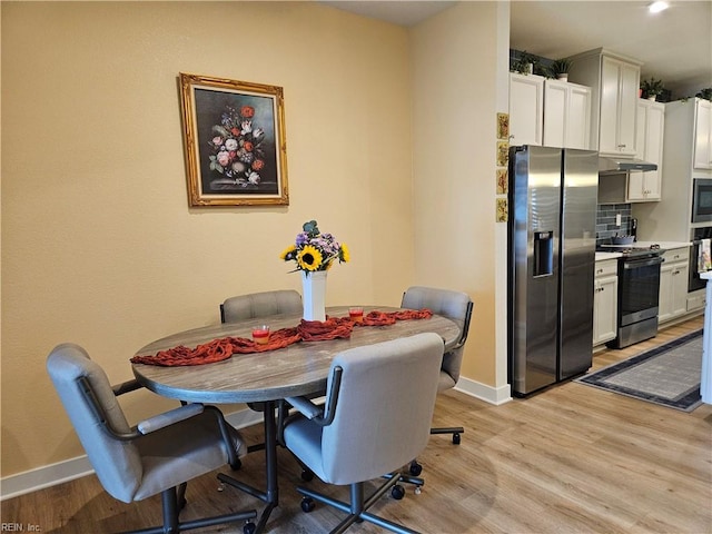 23082 Retreat Ln, Carrollton, VA 23314 - dining area featuring light wood-type flooring and baseboards