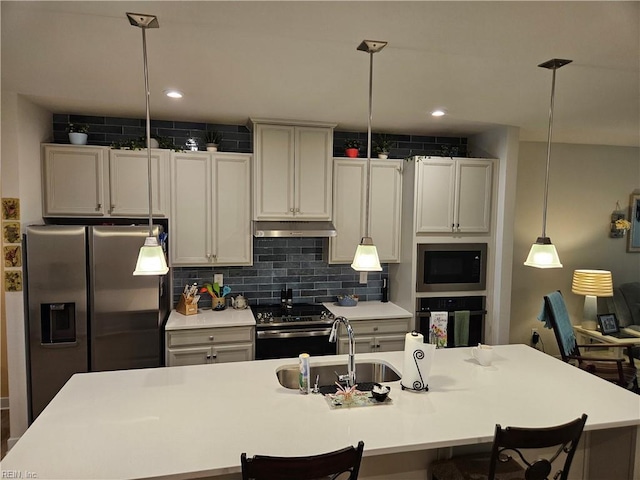 23082 Retreat Ln, Carrollton, VA 23314 - kitchen featuring appliances with stainless steel finishes, light countertops, a breakfast bar, hanging light fixtures, and recessed lighting