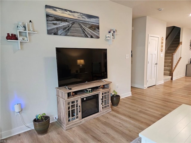 23082 Retreat Ln, Carrollton, VA 23314 - living room with wood finished floors, stairway, and baseboards