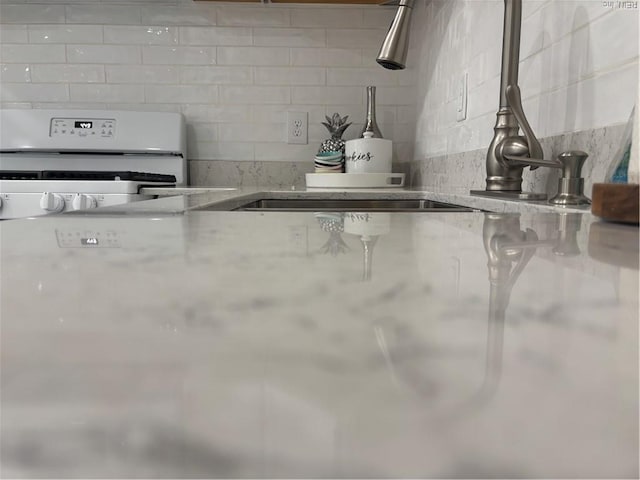 432 Maryle Ct, Newport News, VA 23602 - kitchen featuring white stove, a sink, and light stone countertops