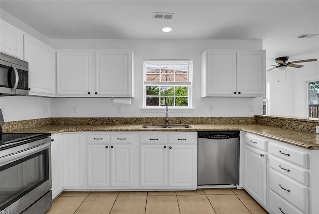 3005 Beech Grove Ln, Suffolk, VA 23435 - kitchen featuring stainless steel appliances, a sink, plenty of natural light, and white cabinetry