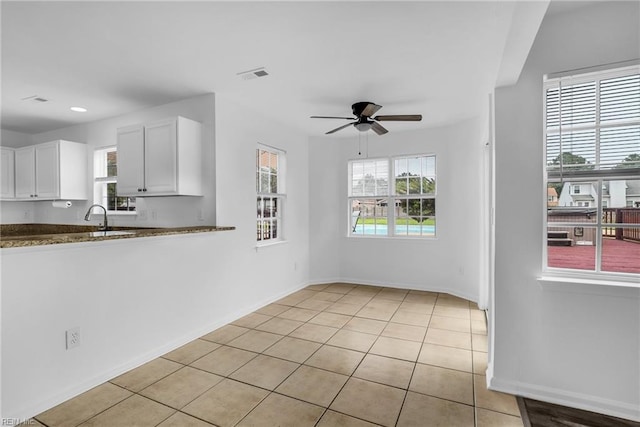 3005 Beech Grove Ln, Suffolk, VA 23435 - kitchen featuring white cabinetry, a ceiling fan, baseboards, light tile patterned flooring, and a sink