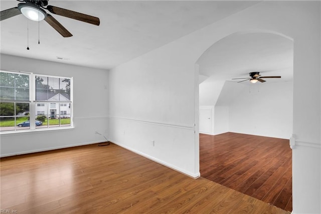 3005 Beech Grove Ln, Suffolk, VA 23435 - unfurnished room featuring ceiling fan, arched walkways, wood finished floors, and baseboards