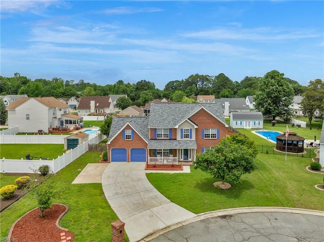 3005 Beech Grove Ln, Suffolk, VA 23435 - traditional home with concrete driveway, a garage, a residential view, brick siding, and covered porch