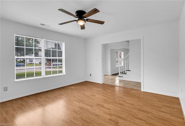 3005 Beech Grove Ln, Suffolk, VA 23435 - empty room with ceiling fan, light wood finished floors, stairs, and baseboards