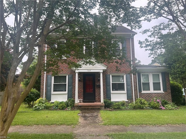 709 Smith St, Suffolk, VA 23434 - view of front of house featuring brick siding and a front yard