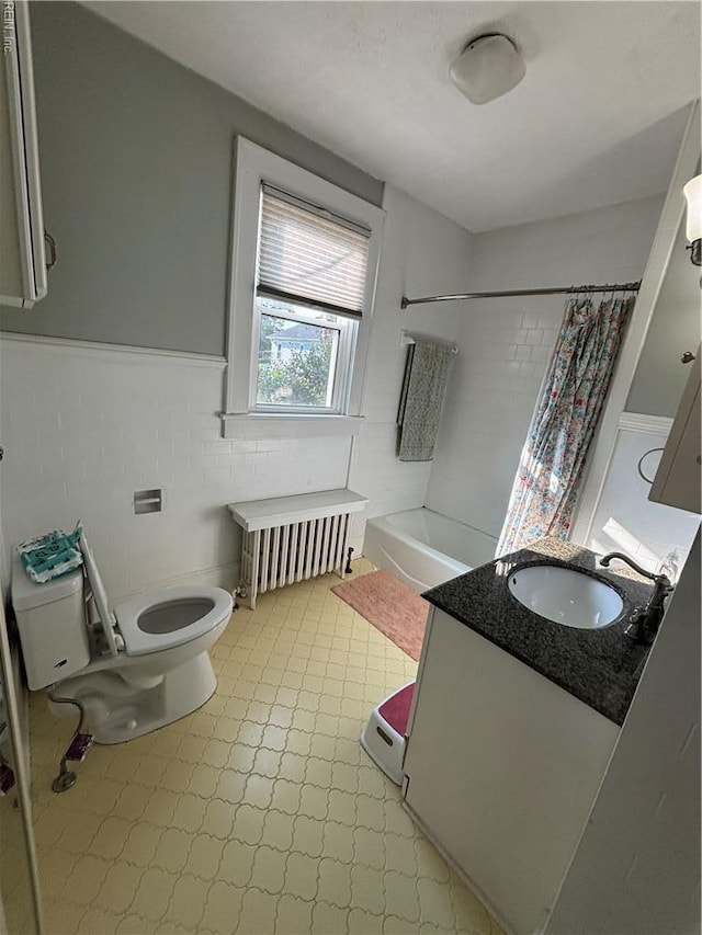 709 Smith St, Suffolk, VA 23434 - bathroom with radiator heating unit, toilet, vanity, wainscoting, and shower / bathtub combination with curtain
