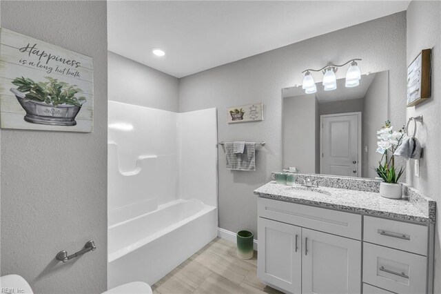 505 Osceola Ave, Suffolk, VA 23434 - full bath featuring toilet, vanity, a textured wall, bathing tub / shower combination, and baseboards