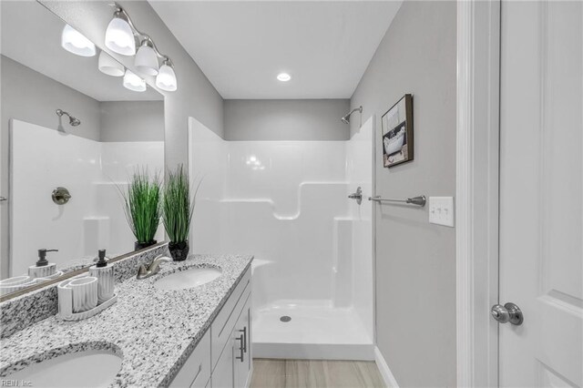 505 Osceola Ave, Suffolk, VA 23434 - full bathroom featuring a walk in shower, double vanity, and baseboards