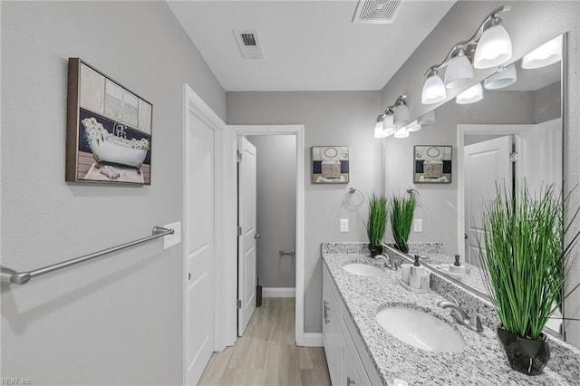 505 Osceola Ave, Suffolk, VA 23434 - bathroom with double vanity, wood finished floors, and baseboards