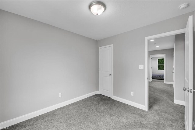 505 Osceola Ave, Suffolk, VA 23434 - unfurnished bedroom featuring dark carpet and baseboards