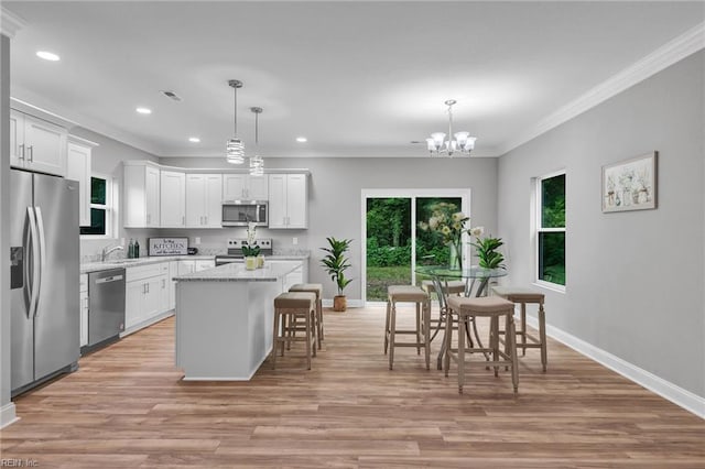505 Osceola Ave, Suffolk, VA 23434 - kitchen with appliances with stainless steel finishes, ornamental molding, a center island, healthy amount of natural light, and recessed lighting