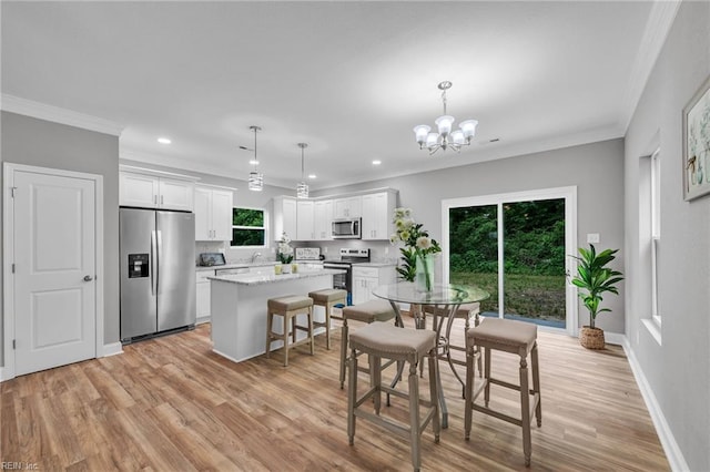 505 Osceola Ave, Suffolk, VA 23434 - dining room with light wood finished floors, crown molding, a chandelier, recessed lighting, and baseboards