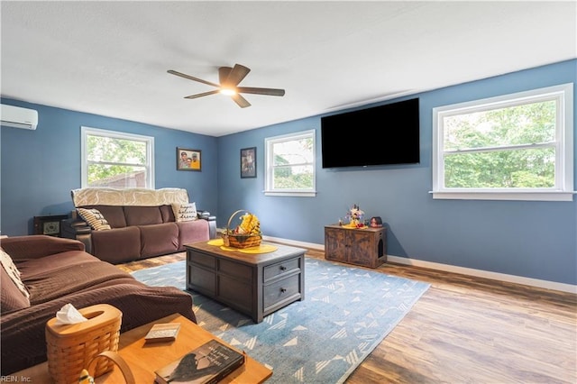 891 Bells Mill Rd, Chesapeake, VA 23322 - living area with an AC wall unit, a ceiling fan, wood finished floors, and baseboards