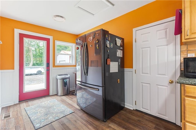891 Bells Mill Rd, Chesapeake, VA 23322 - kitchen with freestanding refrigerator, a wainscoted wall, black microwave, dark wood-style floors, and a decorative wall
