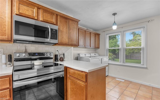 746 Burksdale Rd, Norfolk, VA 23518 - kitchen featuring stainless steel appliances, washing machine and dryer, brown cabinetry, and light tile patterned floors