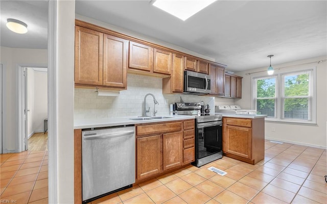 746 Burksdale Rd, Norfolk, VA 23518 - kitchen featuring stainless steel appliances, a sink, light tile patterned floors, and tasteful backsplash