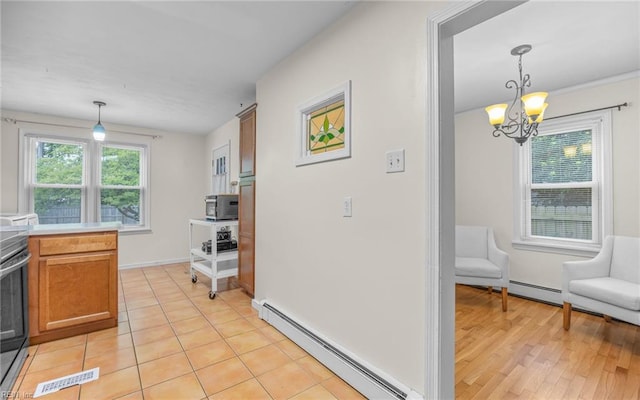 746 Burksdale Rd, Norfolk, VA 23518 - kitchen with baseboard heating, a chandelier, decorative light fixtures, and brown cabinetry