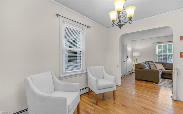 746 Burksdale Rd, Norfolk, VA 23518 - living area with arched walkways, a baseboard heating unit, a chandelier, light wood-type flooring, and ornamental molding