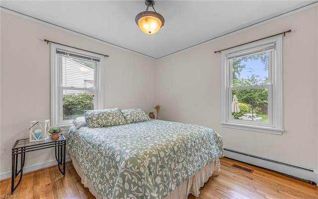 746 Burksdale Rd, Norfolk, VA 23518 - bedroom with a baseboard radiator and light wood-type flooring