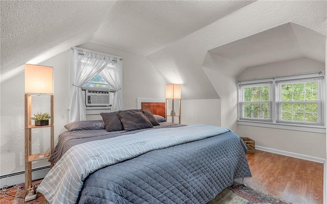 746 Burksdale Rd, Norfolk, VA 23518 - bedroom featuring a baseboard heating unit, lofted ceiling, multiple windows, a textured ceiling, and wood finished floors
