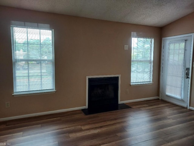 403 Resort Ct, Virginia Beach, VA 23462 - unfurnished living room featuring wood finished floors, baseboards, a textured ceiling, plenty of natural light, and a fireplace