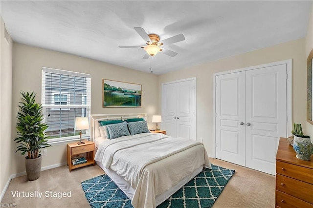 5018 Kings Grant Cir, Suffolk, VA 23434 - bedroom featuring multiple closets, light colored carpet, baseboards, and ceiling fan