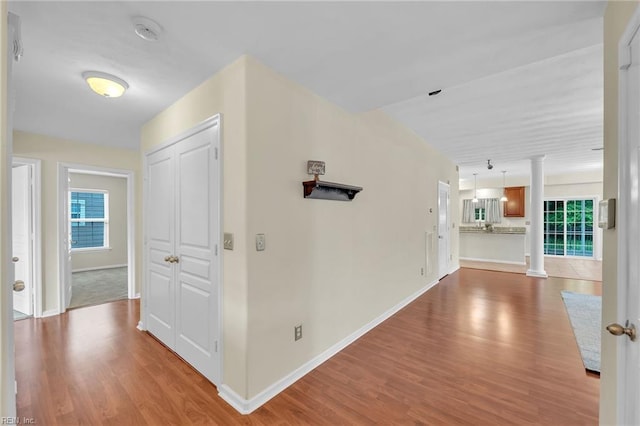 5018 Kings Grant Cir, Suffolk, VA 23434 - corridor with decorative columns, wood finished floors, and baseboards