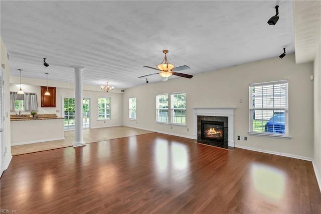 5018 Kings Grant Cir, Suffolk, VA 23434 - unfurnished living room with a ceiling fan, a high end fireplace, wood finished floors, and ornate columns